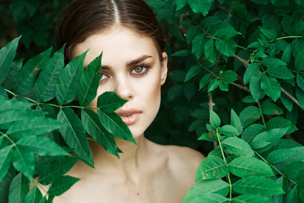 beautiful woman skin care bare shoulders green leaves nature Lifestyle - Фото, изображение