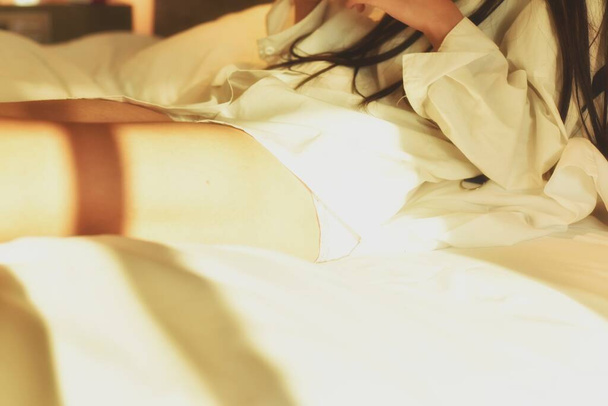 woman lying on bed in bedroom - Foto, Bild