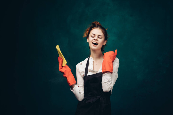 cleaning lady in red rubber gloves with a rag in her hands housekeeping - Foto, afbeelding