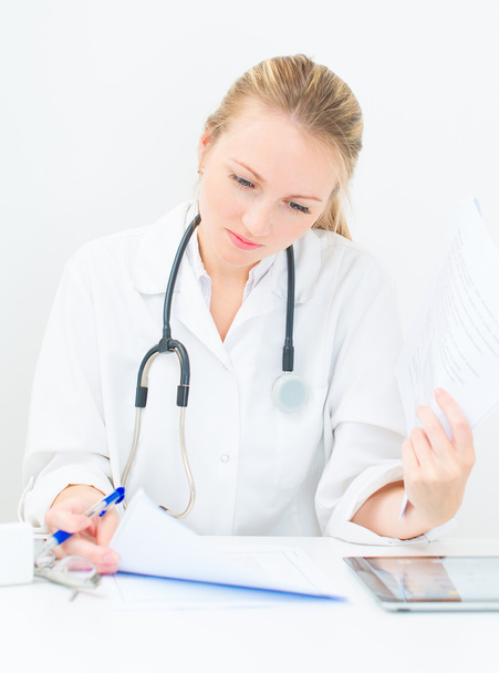 Portrait of female doctor working with documents. - Photo, Image