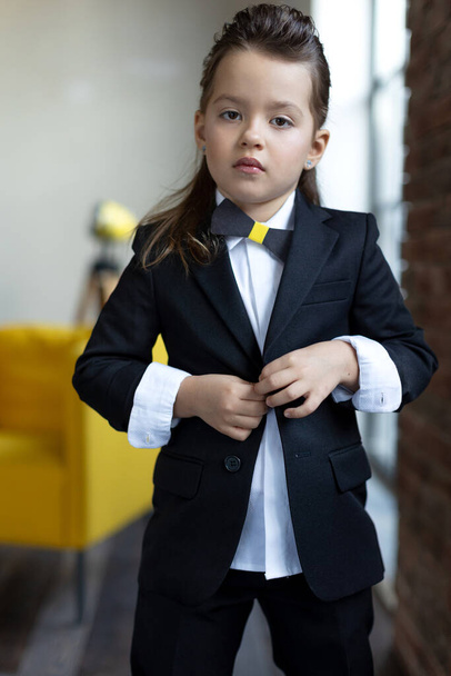 Fashionable child. The little girl is fashionably dressed. School style. - Zdjęcie, obraz