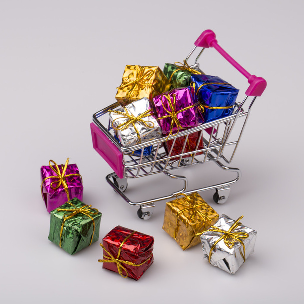 Christmas gifts in shopping trolley, isolated on white - Zdjęcie, obraz