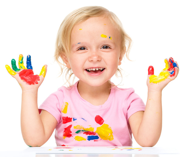 Portrait of a cute little girl playing with paints - Photo, Image