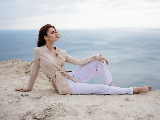 beautiful woman posing near rocks in the sand model Travel - Фото, изображение