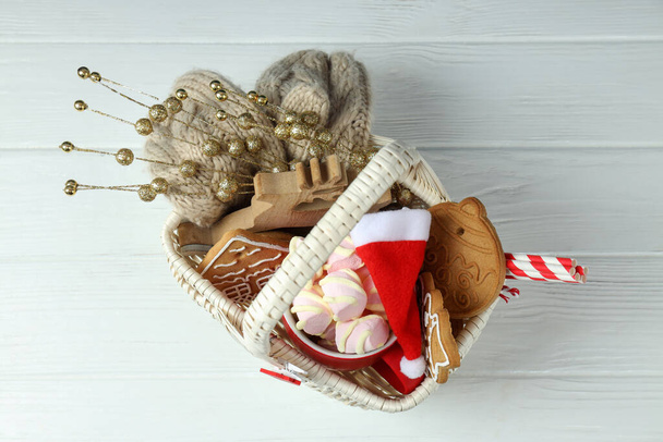 Koncepcja prezentu z koszykiem świątecznym na białym drewnianym tle - Zdjęcie, obraz