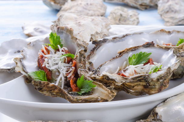 Oysters with parmesan and baked tomatoes - 写真・画像