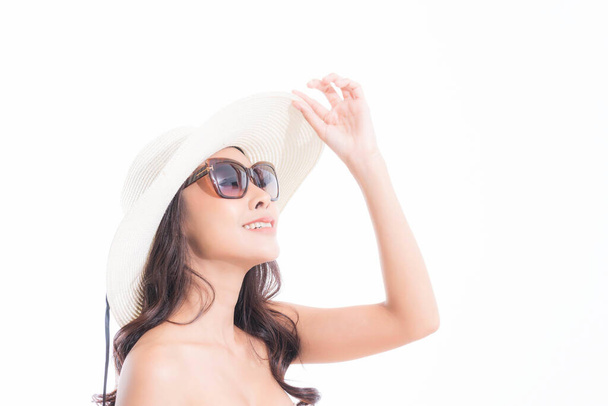 Κοντινό πλάνο, Όμορφη γυναίκα προσωπογραφία σε καπέλο ήλιο και γυαλιά ηλίου απολαμβάνοντας με ήλιο στο στούντιο πυροβόλησε απομονώνονται σε λευκό φόντο. Έννοια ηλιακής προστασίας. - Φωτογραφία, εικόνα