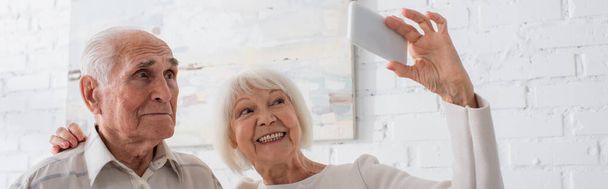 Elderly people smiling while taking selfie in nursing home, banner  - Foto, imagen