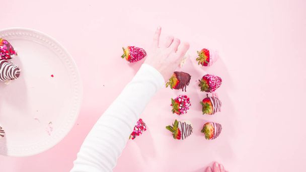 Flat lay. Step by step. Variety of chocolate dipped strawberries on a pink background. - Photo, Image