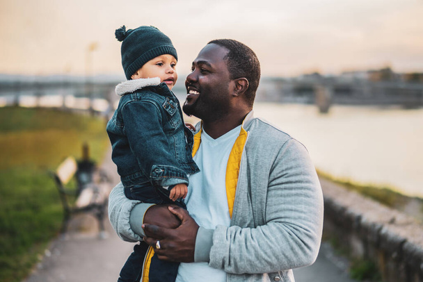 Portrait of father and his son enjoy spending time together outdoor. - Fotó, kép