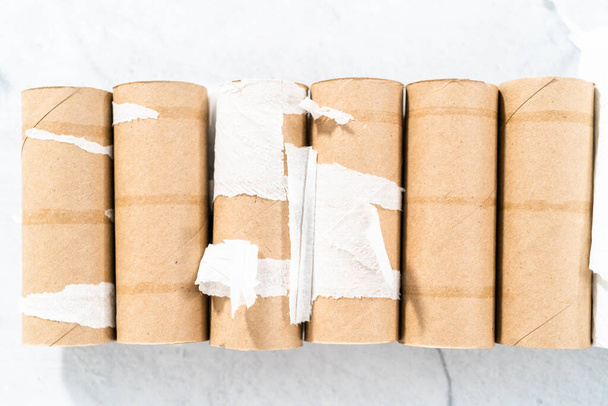 Used empty toilet paper rolls on a gray background. - 写真・画像