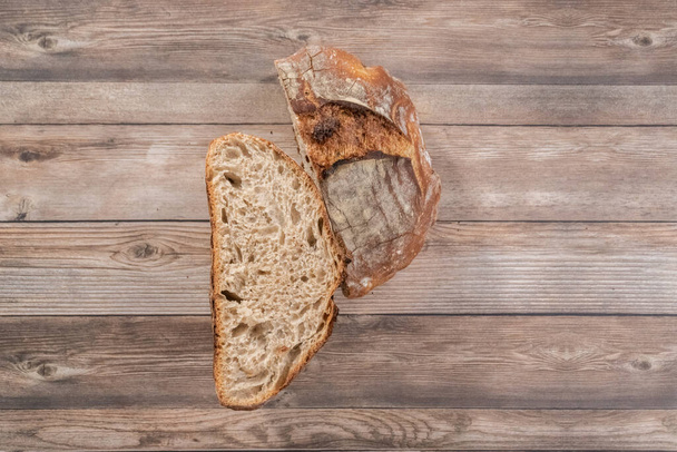 Flat lay. Sliced baked sourdough rye loaf of bread. - Foto, Imagem