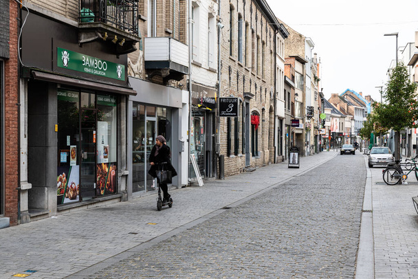 Vilvoorde, Flemish Region - Belgium - 10 17 2021: Young woman driving a step in the shopping street - Foto, Bild