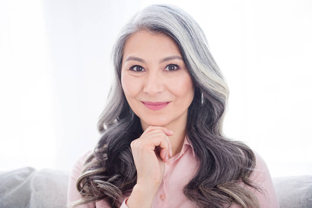 Portrait of attractive cheery calm gray-haired woman staying alone enjoying free time at home house indoor - Фото, изображение
