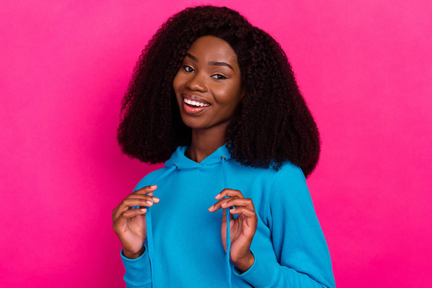 Photo of pretty attractive dark skin young woman good mood wear blue sweatshirt isolated on pink color background - Photo, image