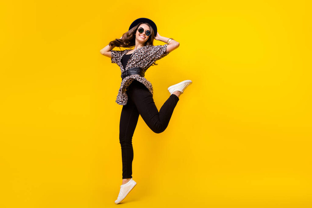 Full length photo of attractive young charming woman jump up wear sunglass hat isolated on yellow color background - Photo, Image