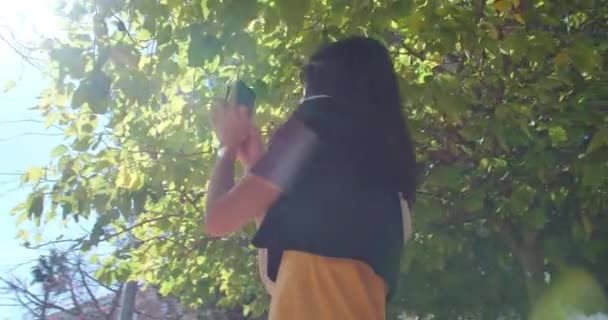 Female touristic in sunglasses using smartphone camera for making video - Video