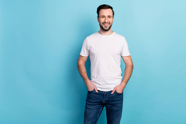 Portrait of attractive cheerful experienced guy expert holding hands in pockets isolated over blue bright pastel color background. - Φωτογραφία, εικόνα