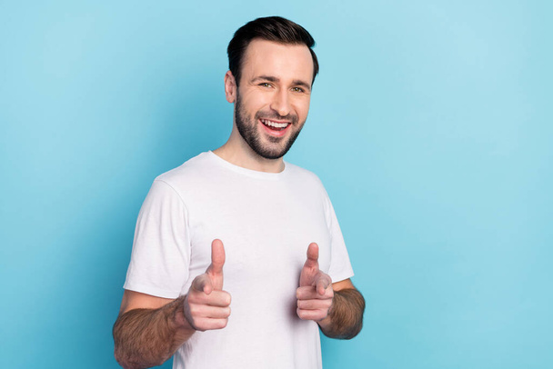 Portrait of attractive cheerful guy showing sign invite you best laughing isolated over blue bright pastel color background. - Foto, Imagem