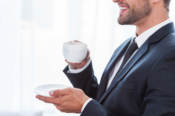 Businesswoman in suit drinking coffee - Valokuva, kuva