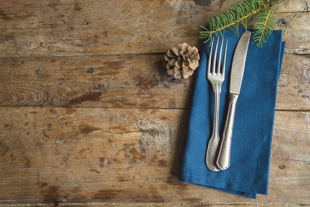 Christmas holiday background; vintage fork, knife and blue napkin - 写真・画像