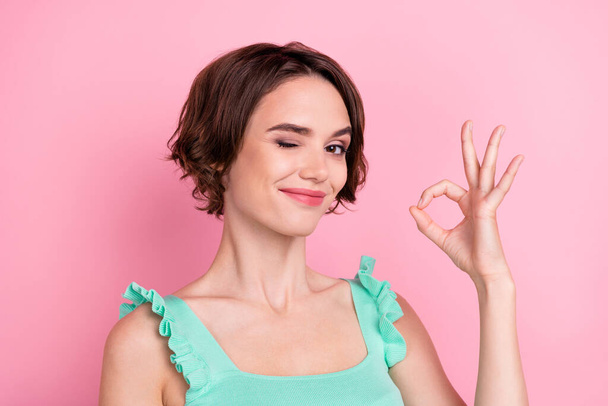 Portrait of attractive cheerful content girl showing ok-sign winking advert isolated over pink pastel color background. - Fotografie, Obrázek