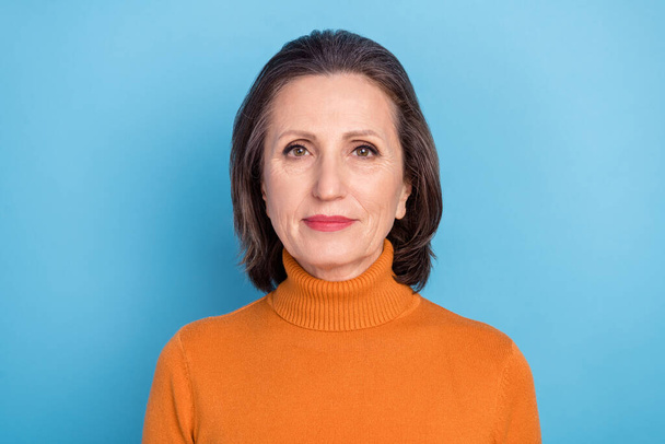 Photo of smart intelligent aged lady calm face look camera isolated on bright blue color background - Fotó, kép