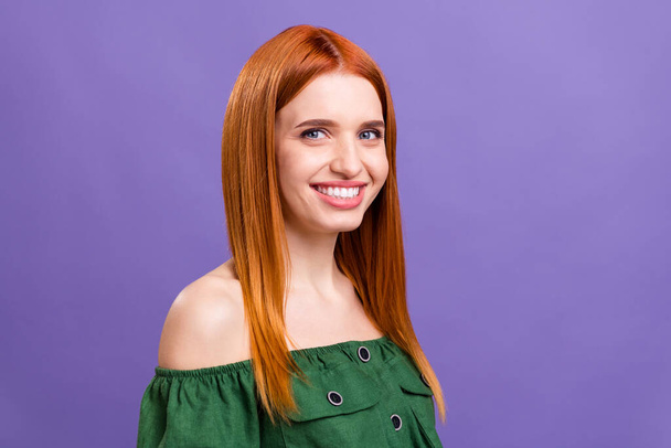 Photo of cute shiny young lady wear green blouse smiling empty space isolated purple color background - Foto, afbeelding