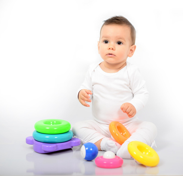 Beautiful baby girl with colorful toys - Studio shot - Foto, afbeelding