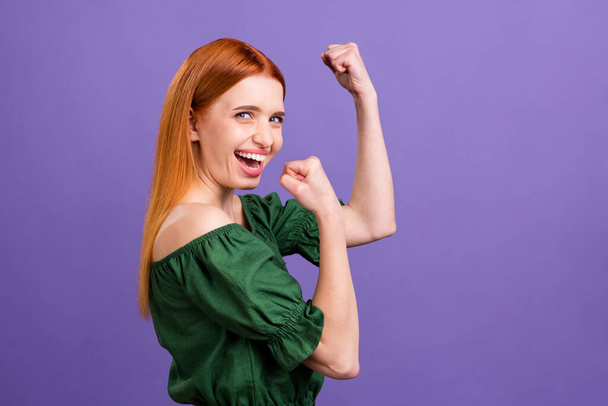 Profile photo of hooray red hair millennial lady hands fists wear green open shoulders blouse isolated on violet color background - Zdjęcie, obraz