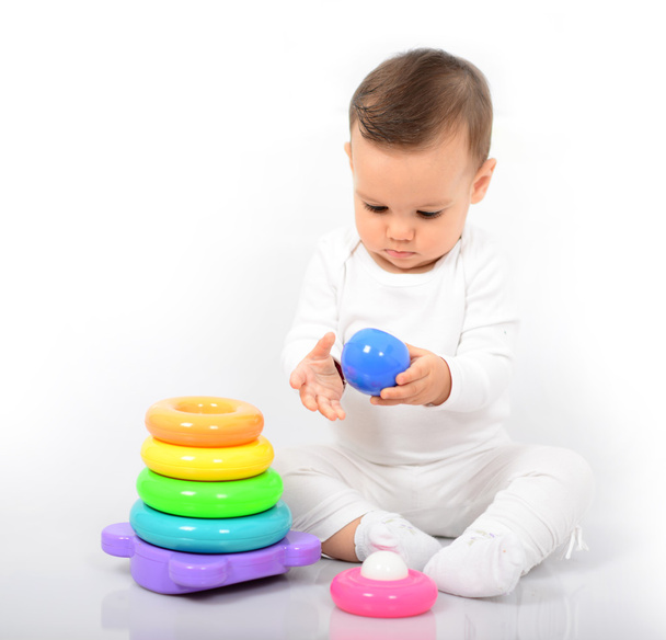 Beautiful baby girl with colorful toys - Studio shot - Foto, Imagem