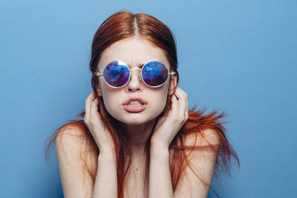 mujer atractiva con hombros desnudos gafas de moda fondo azul - Foto, Imagen