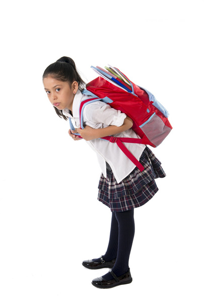 sweet little girl carrying very heavy backpack or schoolbag full - Fotó, kép