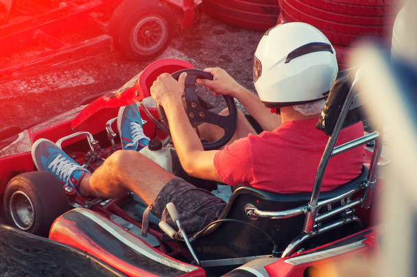 Чоловіки керують автомобілем Go-card зі швидкістю в ігровому майданчику гоночної доріжки
. - Фото, зображення