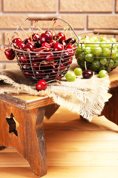 Fresh berries in basket on wall background - Photo, Image