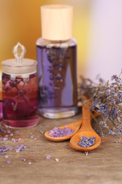 Spa still life with lavender oil and flowers on wooden table, on light background - Foto, Imagem