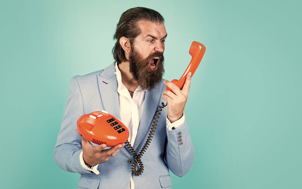 do you hear me. bearded hipster use retro telephone. communication concept. brutal handsome man with moustache speak on phone. call and conversation. modern and vintage technology - Foto, afbeelding