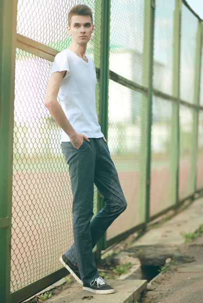 Fashionable handsome man model posing outdoors in summer day - Foto, Imagem