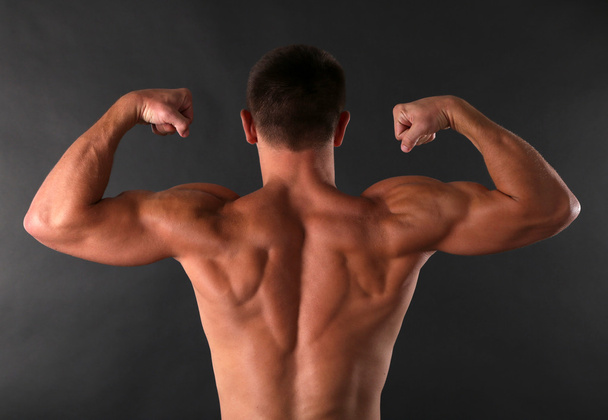 Handsome muscle young man on dark background - Foto, Bild