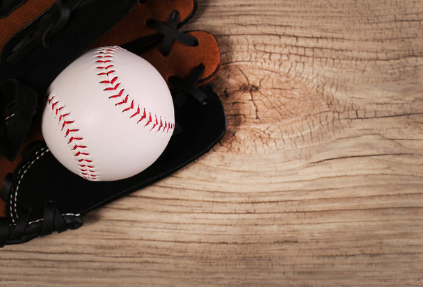 Baseball. Ball in Glove over wood background with copy space.  - Photo, image
