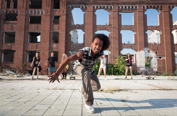 Energetic street dancer lunging at the camera - Photo, Image