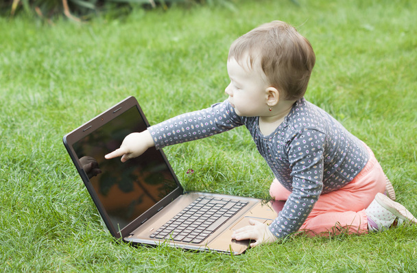 Cute baby girl using a laptop - Foto, imagen