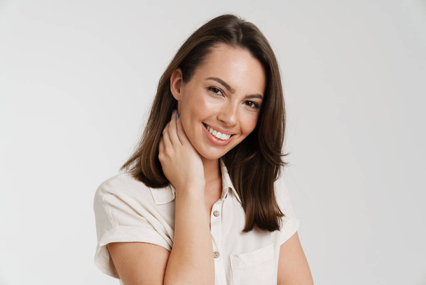 Young european woman smiling and looking at camera isolated over white background - Φωτογραφία, εικόνα