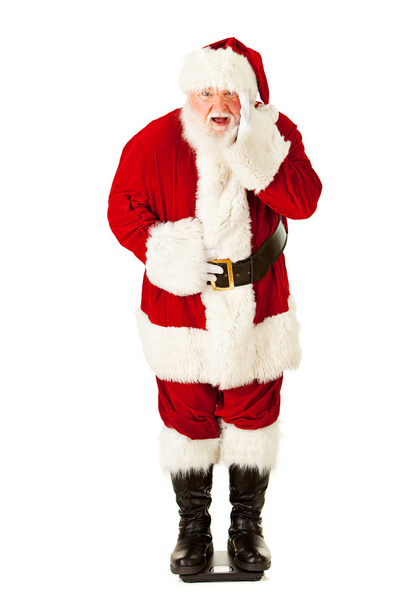 Weihnachtsmann: Weihnachtsmann kontrolliert Gewicht auf Waage - Foto, Bild