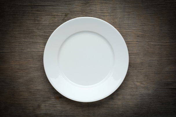 Empty  white plate on wooden background - Zdjęcie, obraz