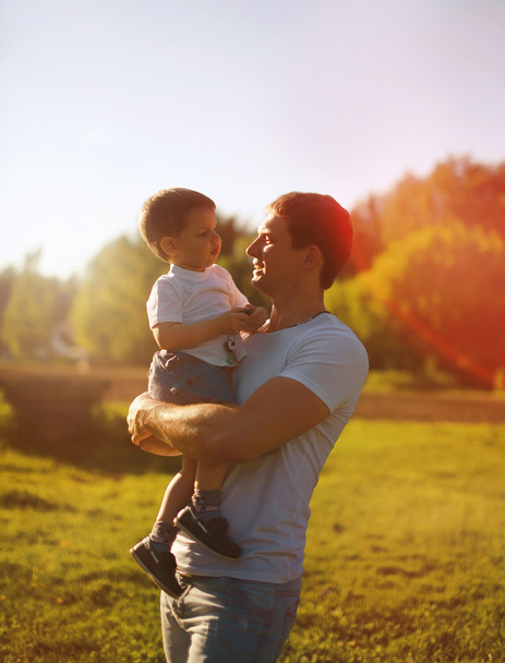 Beautiful evening sunset, happy father and son, summer, sunny ph - Photo, Image