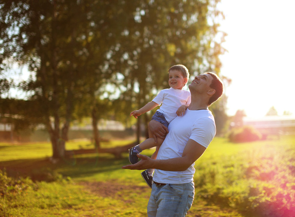Happy father and son having fun, enjoying sunny summer day - Photo, image