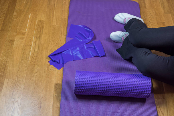 Close up view of woman's legs on training mat after exercising at home. Sweden. - Photo, Image