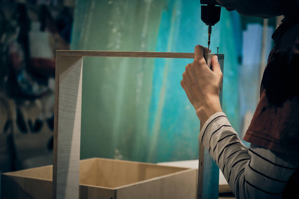 Woman assembling furniture at workshop - Foto, Bild