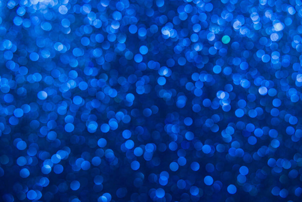 Texture created from oval blue objects. The effect was obtained by photographing the glitter surface in a macro scale without focusing. - Photo, Image